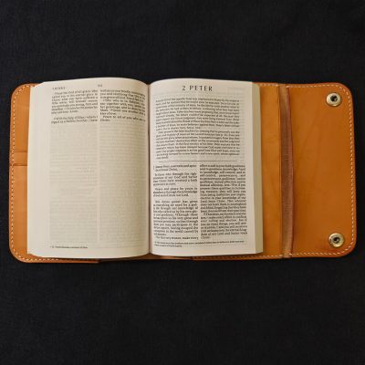 leather bible cover double closure black background bible