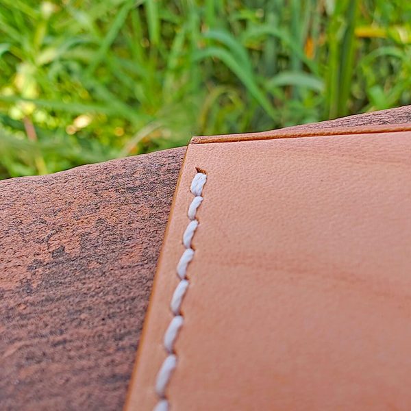 the stitching starting point of the leather card holder is reinforced with double stitching